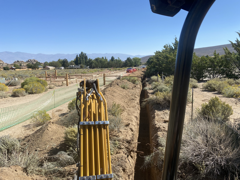 A view from a mini excavator down the trench