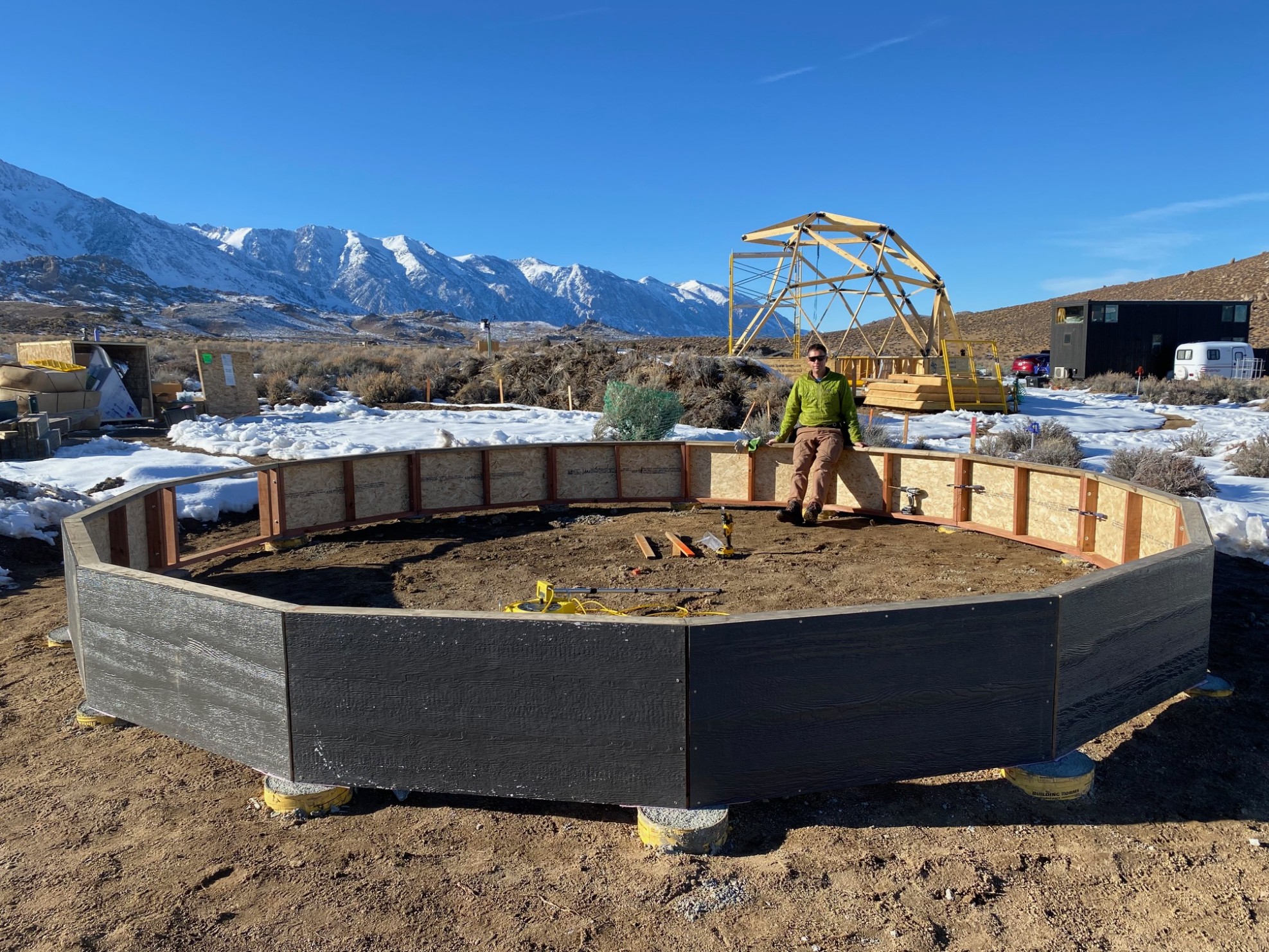 A man relaxing in the sun on a circle of riser walls