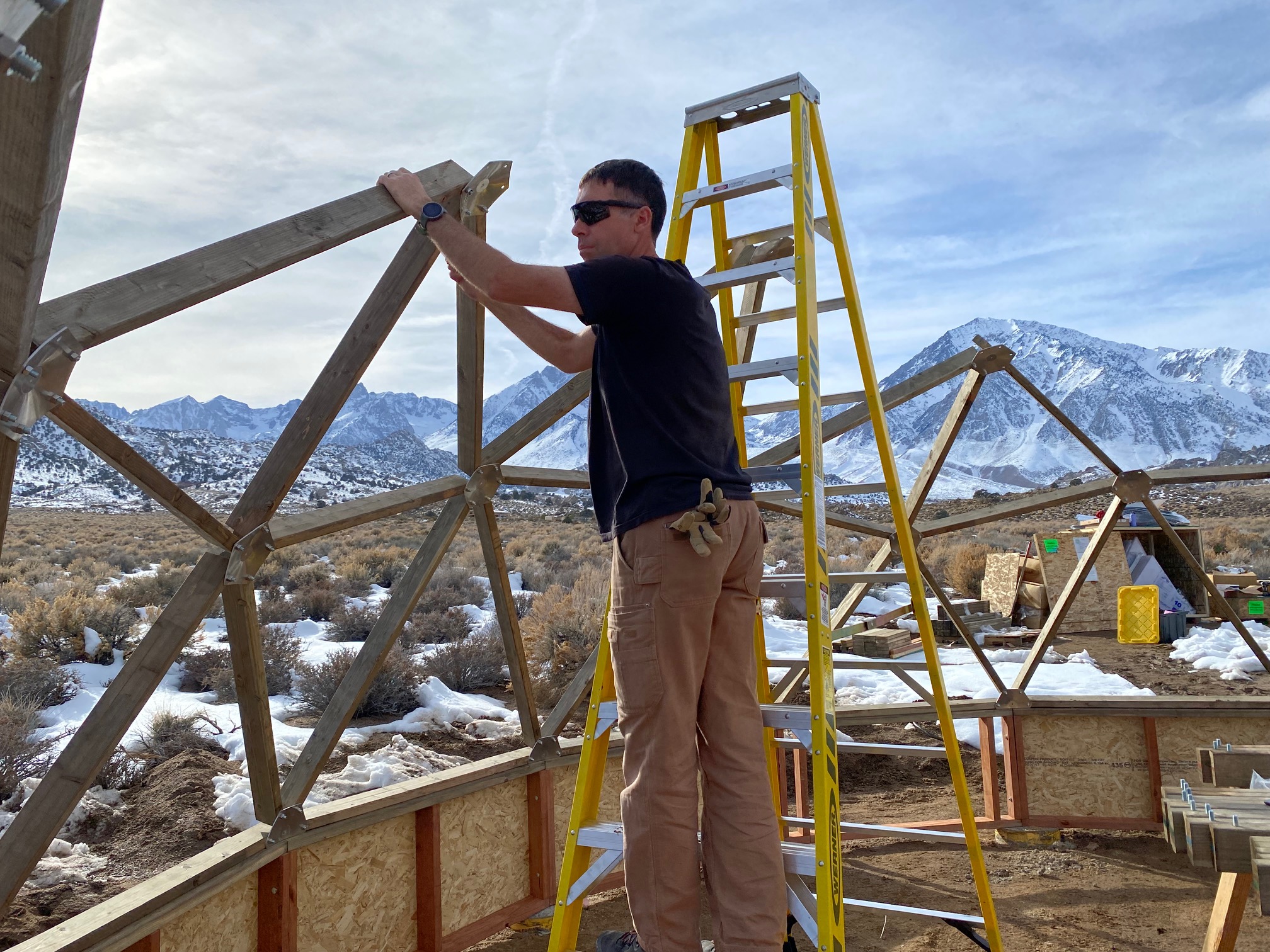 A man attaching some struts to a center plate