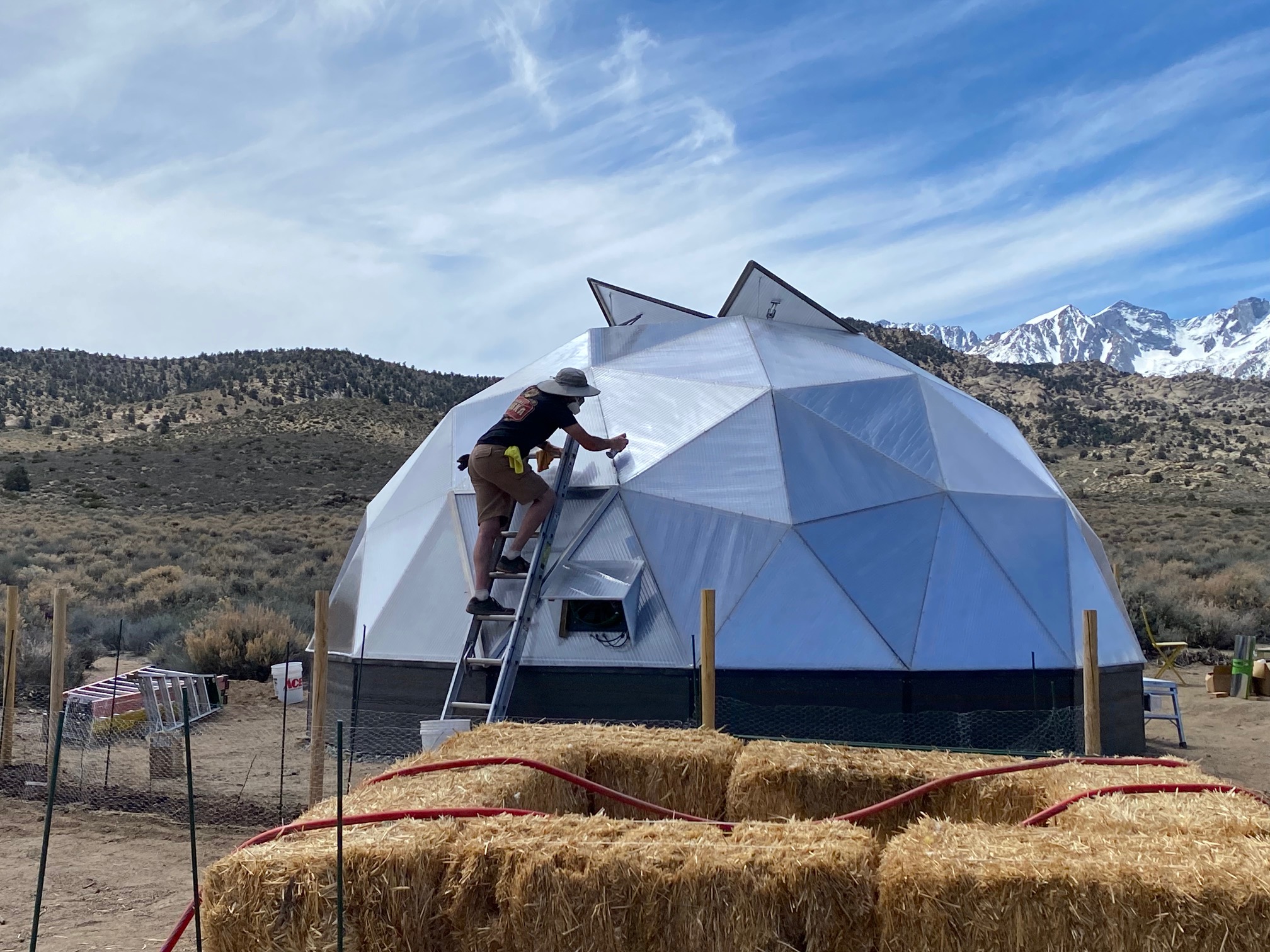 A man spraying a can on a dome surface