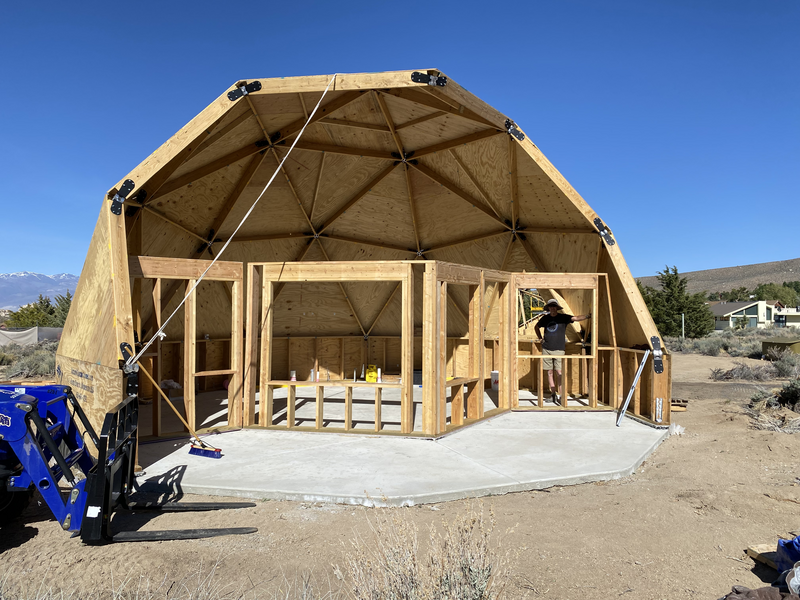 Front of geodesic half dome with vertical walls on first floor in a zig zag