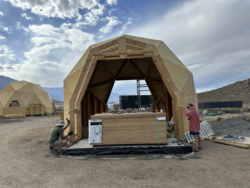 2 people working to attach an extension arch