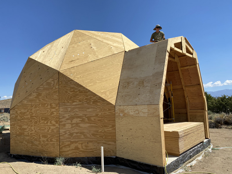 A man up at the top of a dome extension