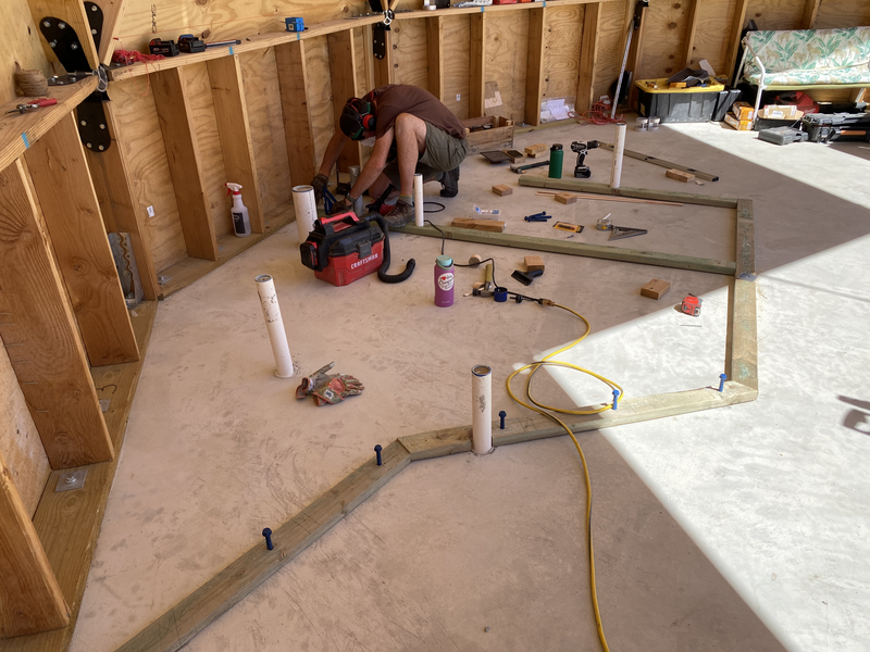 a man drilling into concrete floor