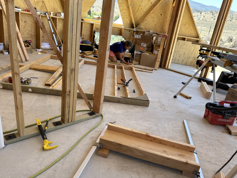 woman framing a wall on the floor